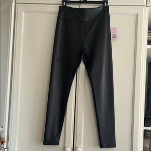 Sleek black leggings. 88% polyester 12% spandex. Shiny “leather look”.